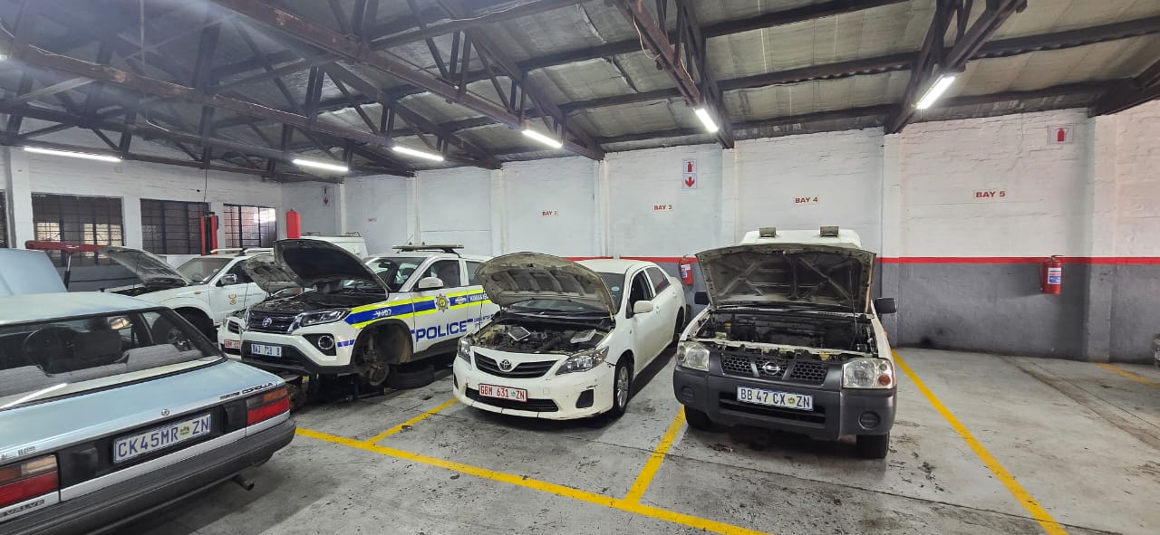 Several vehicles in service bays inside the workshop