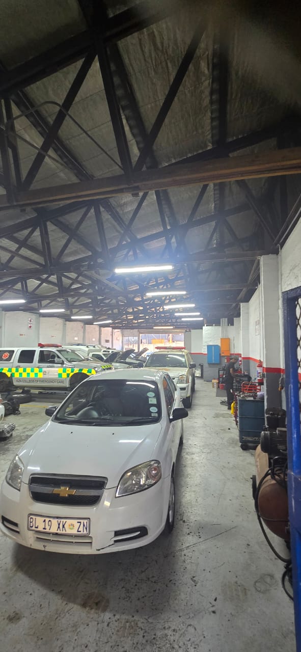 View down the workshop floor with vehicles and work areas